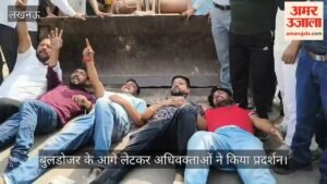 VIDEO: दारू की दुकान नहीं तोड़े जाने के विरोध में अधिवक्ताओं ने बुलडोजर के आगे लेटकर प्रदर्शन किया